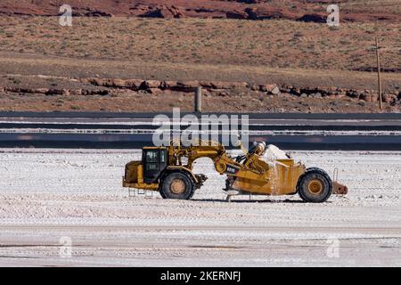 A heavy-duty scraper harvesting potash from an evaporation pond at a potash mine  near Moab, Utah. Stock Photo