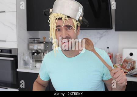 Chaotic chef trying to make some pasta Stock Photo
