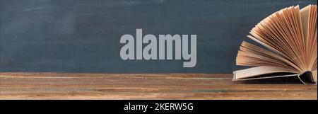 Open Book on dark background education,reading,knowledge concept.Panoramic, large copy space. Stock Photo