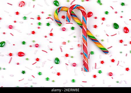 Christmas background of colorful candies, cane lollipops on a white background, close-up Stock Photo