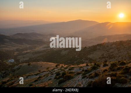 View of the landscape of central Greece as seen from the Mount Olympus massif at sunset Stock Photo
