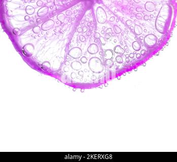 Juicy lime slices with bubbles under water isolated on white background. Purple lemon slices pattern textured background. Stock Photo