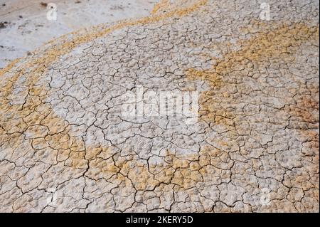 Cracked white-yellow clay. Hot climate in the desert. Stock Photo