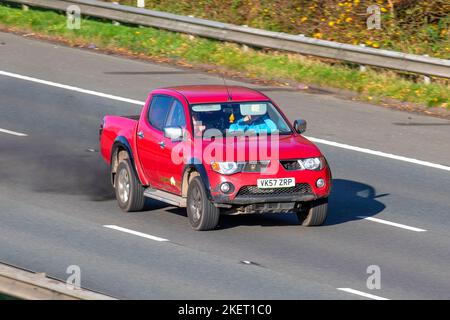 2007 Red MITSUBISHI L200 4WD SHR 4LIFE DCB 2477cc 5 Speed manual pick-up truck, emitting black exhaust smoke & diesel particles from damaged engine travelling on the M61 Motorway UK Stock Photo