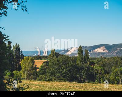 Panoramic view of fields and mountains with nuclear smokestacks at Cruas, Southern France Stock Photo