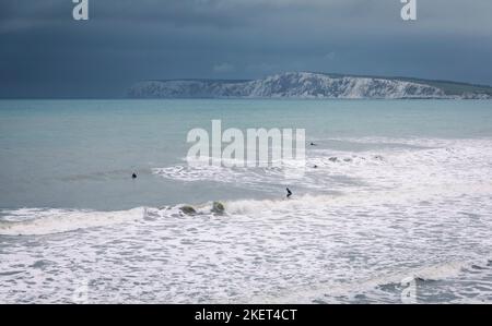 Surfing in the stormy waters at high tide at Compton Bay Isle of Wight south east England Stock Photo