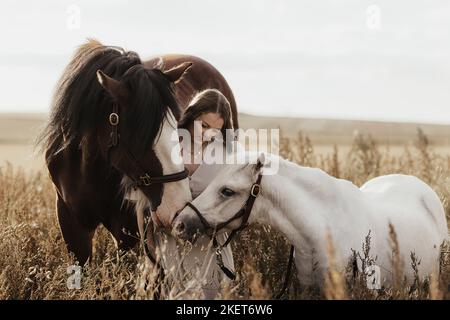woman and 2 horses Stock Photo