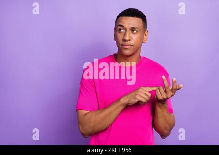 Portrait photo of young minded guy count down looking empty space ponder face idea how pay his employer salary isolated on violet color background Stock Photo