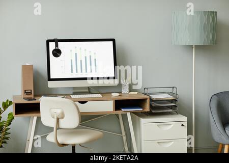 Background image of minimal workplace interior in white tones with PC computer on desk, copy space Stock Photo