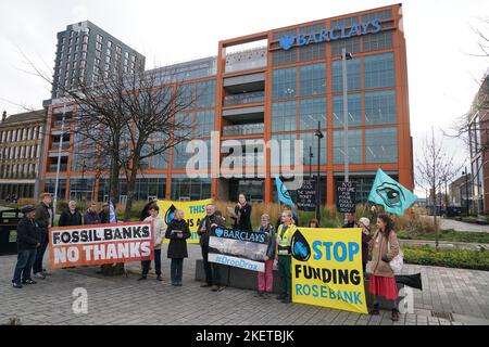 Members from Extinction Rebellion Scotland protesting outside Barclays Clyde Place Quay branch in Glasgow as they demand Barclays cut its ties with fossil fuel firms. The protest is part of Extinction Rebellion and Money Rebellion's UK-wide Better without Barclays campaign of disruption. Picture date: Monday November 14, 2022. Stock Photo