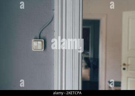 Vintage electric light switch on bedroom wall, selective focus Stock Photo