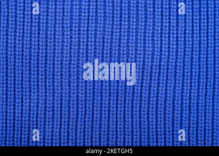 Blue knitted fabric background, texture. Abstract pattern. Stock Photo