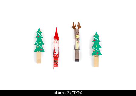 Christmas clothespins on white background isolated, flat lay. Stock Photo