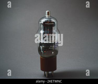 Old vacuum tube on gray background Stock Photo