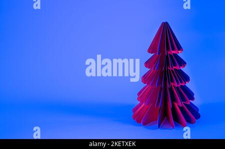 Decorative paper Christmas tree on blue background with trendy neon light. Stock Photo