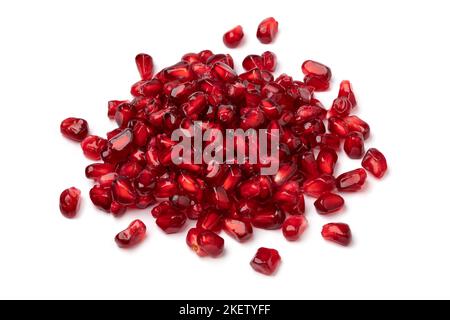 Heap of fresh red pomegranate seeds isolated on white background close up Stock Photo