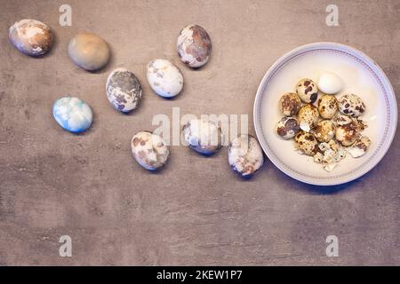 eggs on concrete. Happy Easter card: marble stone effect painted. top view, quail eggs flat lay Stock Photo