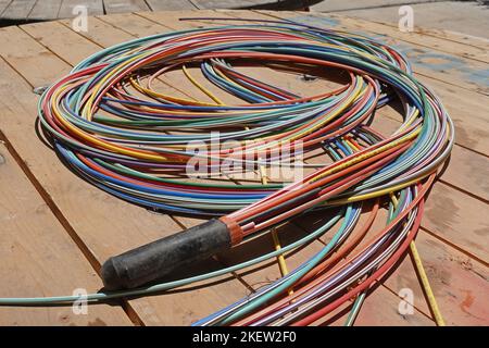 Athens, Greece - August 6, 2022: Fiber optic cables color coded bundle of telecommunication internet wires for underground placement. Stock Photo