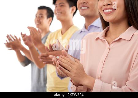 Cropped image of happy people smiling and clapping Stock Photo