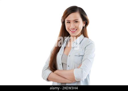 Portrait of smiling young Asian woman standing with her arms cropped Stock Photo