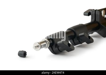 close-up of studio light stand with screw head, black color adjustable tripod isolated on white background, taken in selective focus Stock Photo