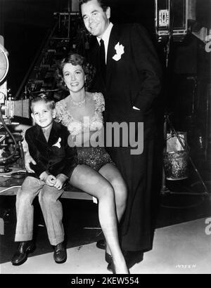 ELEANOR POWELL with set visitors husband GLENN FORD with their 5-year-old son PETER FORD on set candid in late 1949 during filming of her guest dance spot (and last film appearance) in DUCHESS OF IDAHO 1950 director ROBERT Z. LEONARD Metro Goldwyn Mayer Stock Photo