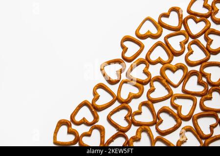 Heart-shaped salty pretzels on white background Stock Photo