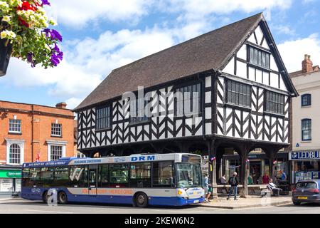 Local bus at bus stop by 17th century Market House, Market Place, High Street, Ledbury, Herefordshire, England, United Kingdom Stock Photo