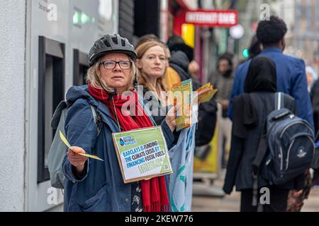 Clapham Junction, England. 14th November 2022. Wandsworth Extinction Rebellion campaigners doing outreach at a Barclays Bank Branch. Stock Photo