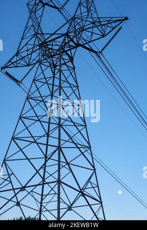 Massive towers carry high voltage electricity across the countryside. Stock Photo