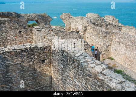 Sirmione Grotte di Catullo, view of tourists visiting the ruins of an ancient Roman building believed to be the villa of Catullus, Lake Garda Italy Stock Photo