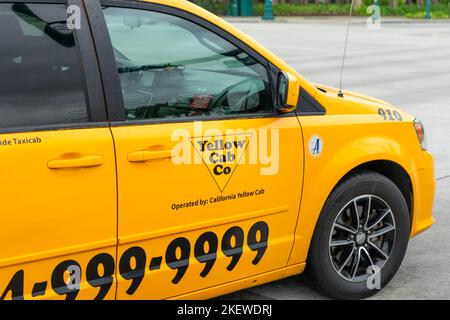 Anaheim, CA, USA – November 2, 2022: A taxi car for the Yellow Cab Company in Orange County traveling in Anaheim, California. Stock Photo