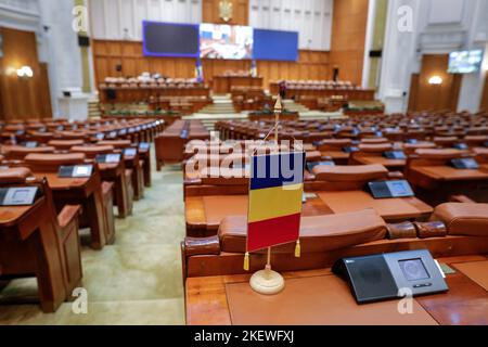 Bucharest, Romania - November 14, 2022: Romanian flag and empty seats in the Romanian Chamber of Deputies inside the Palace of Parliament. Stock Photo