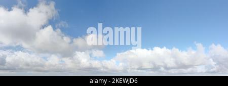 Bright blue dramatic cloudy sky at the horizon. Long panoramic view with copy space on the sky Stock Photo