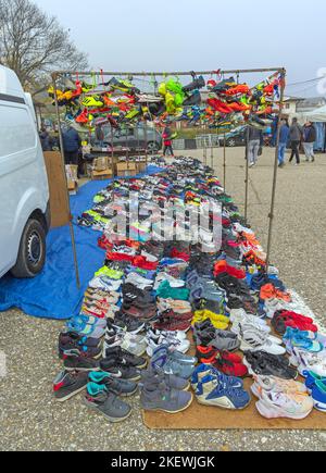 Belgrade, Serbia - October 29, 2022: Colourful Sneakers Cleats Soccer Football Sports Shoes Hanging by Laces at Flea Market. Stock Photo