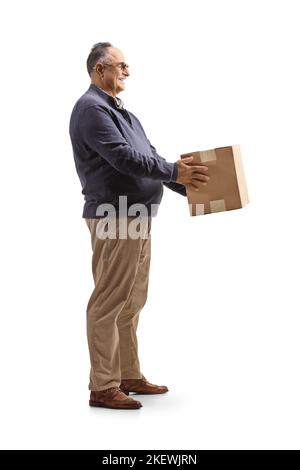 Full length profile shot of a mature man holding a cardboard box isolated on white background Stock Photo