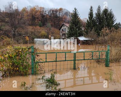 View of torrential rain causes flash floods in residential areas. Houses and roads surrounded by water. Climate change. Heavy rainfall. Stock Photo