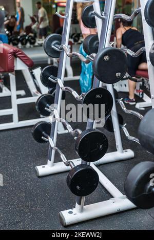 Modern Gym Room Fitness Center With Equipment And Machines. Interior of modern gym fitness room with large windows and treadmills Stock Photo