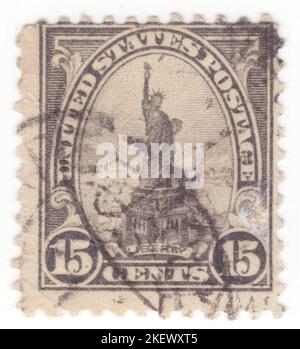 USA - 1922: An 15 cents grey postage stamp depicting Statue of Liberty. Colossal neoclassical sculpture on Liberty Island in New York Harbor in New York City, in the United States. The copper statue, a gift from the people of France, was designed by French sculptor Frédéric Auguste Bartholdi and its metal framework was built by Gustave Eiffel. The statue was dedicated on October 28, 1886. The statue is a figure of Libertas, a robed Roman liberty goddess. She holds a torch above her head with her right hand, and in her left hand carries a tabula ansata Stock Photo