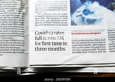 'Covid-19 rates fall across UK for first time in three months' Guardian newspaper headline health clipping virus article 11 November 2022 London UK Stock Photo