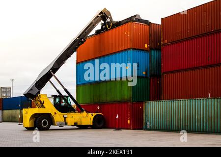 Container handlers. Forklift truck in shipping yard. Industrial container logistic yard. Logistics import export concept. Stock Photo