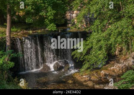 Scenic summer landscape of waterfall amidst green foliage in the Boulzane river valley, Gincla, Aude, France Stock Photo