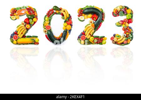 New Year 2023 made of vegetables, fruits and fish on white background. New years 2023 healthy food. New year 2023 food trends. 2023 resolutions, trend Stock Photo