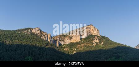 Scenic summer landscape panoramic view of rocky mountain ridge and forest under bright blue sky in the Boulzane river valley near Gincla, Aude, France Stock Photo