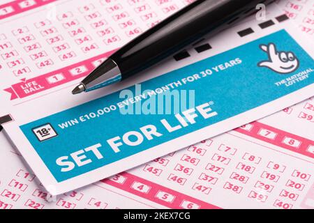 SET FOR LIFE blank lottery tickets and the black pen placed on top. Concept. Selective focus. Stafford, United Kingdom, November 14, 2022 Stock Photo