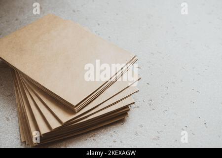 A stack of craft paper envelopes on a table. Stock Photo