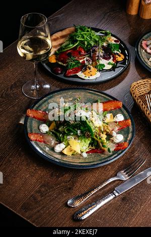 salad with salmon vegetables and herbs Stock Photo