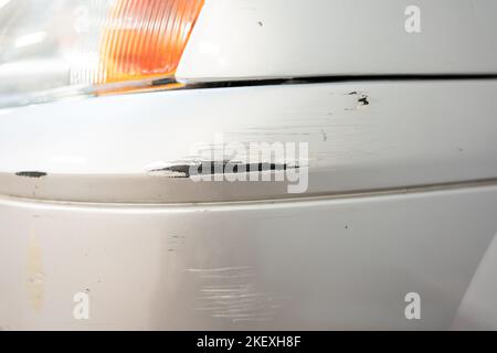 Close up of gray scratched car with damaged paint in crash accident. Stock Photo