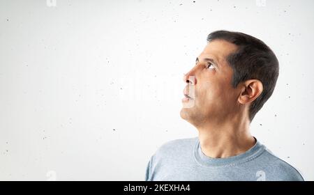 Portrait of a surprised young man looking up with copy space Stock Photo