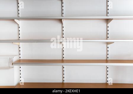 Supermarket empty shelves from front on white background Stock Photo